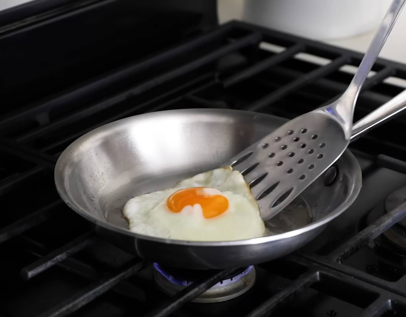 pan with egg on gas stove